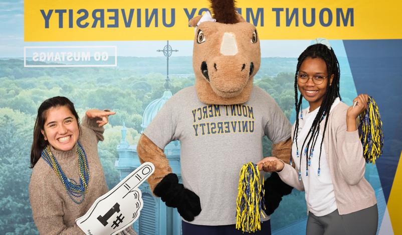 Students posing for a photo with Mustang Sally 